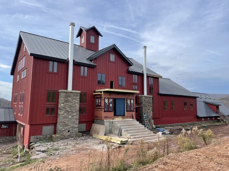 The big red barn with its stone base and cupola