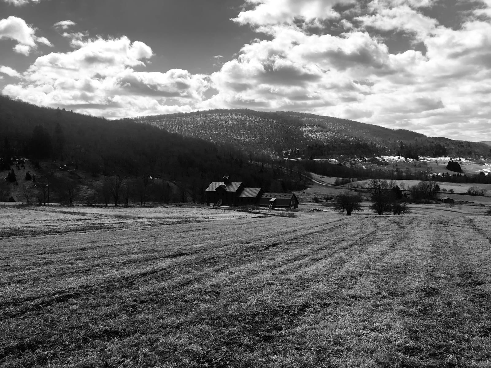 Black-and-white view over the folded Catskill valley below the farm
